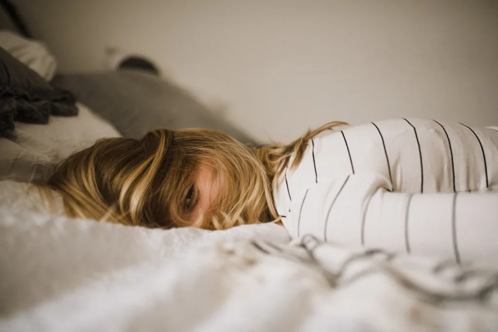 Sleep Hygiene - woman lying on bed