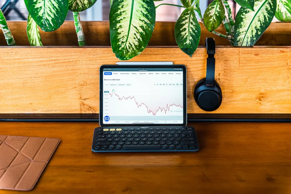 Dollar Cost Average - a laptop computer sitting on top of a wooden desk