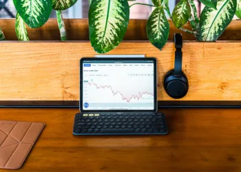 Dollar Cost Average - a laptop computer sitting on top of a wooden desk