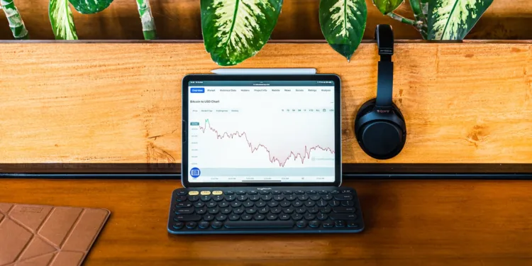Dollar Cost Average - a laptop computer sitting on top of a wooden desk