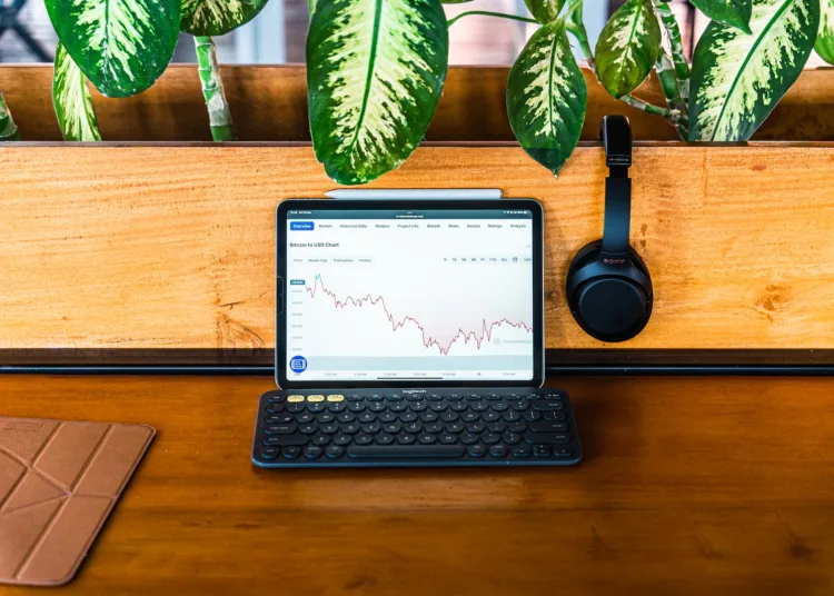 Dollar Cost Average - a laptop computer sitting on top of a wooden desk