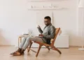 Financial Freedom - Man Sitting With a Laptop on his Lap