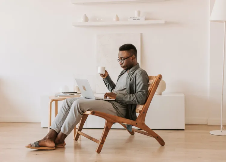 Financial Freedom - Man Sitting With a Laptop on his Lap