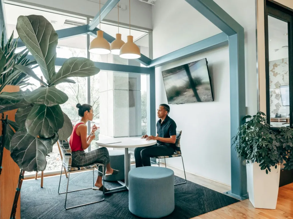 Passive Income - A Man and Woman Sitting on the Chair while Looking at Each Other