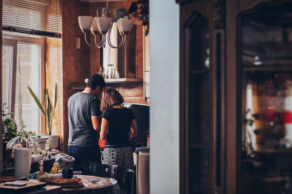 Renting vs Buying a Home - man and woman standing in front of gas range