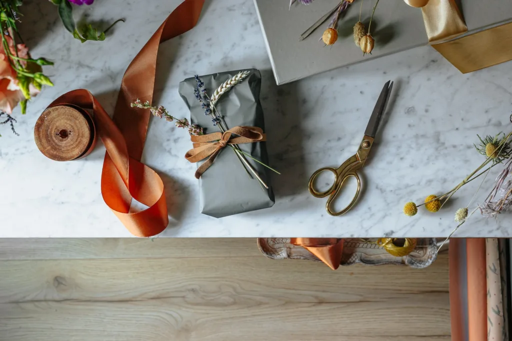 Save on Christmas gifts - silver scissors beside orange leather shoe